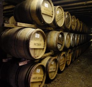 A large stock of wooden Whiskey barrels ageing in a warehouse on the island of Islay in Scotland.